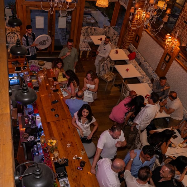 Overhead view of a lively Darvish Kitchen bar and dining area with many patrons.