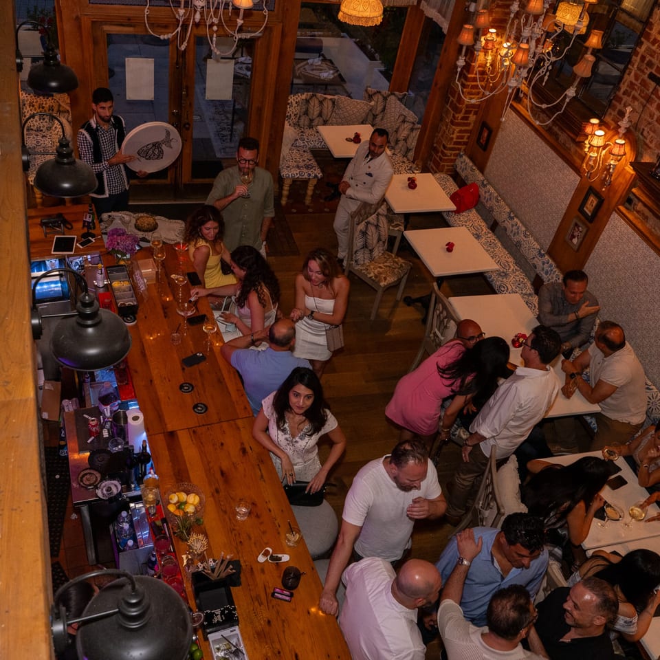 Overhead view of a lively Darvish Kitchen bar and dining area with many patrons.